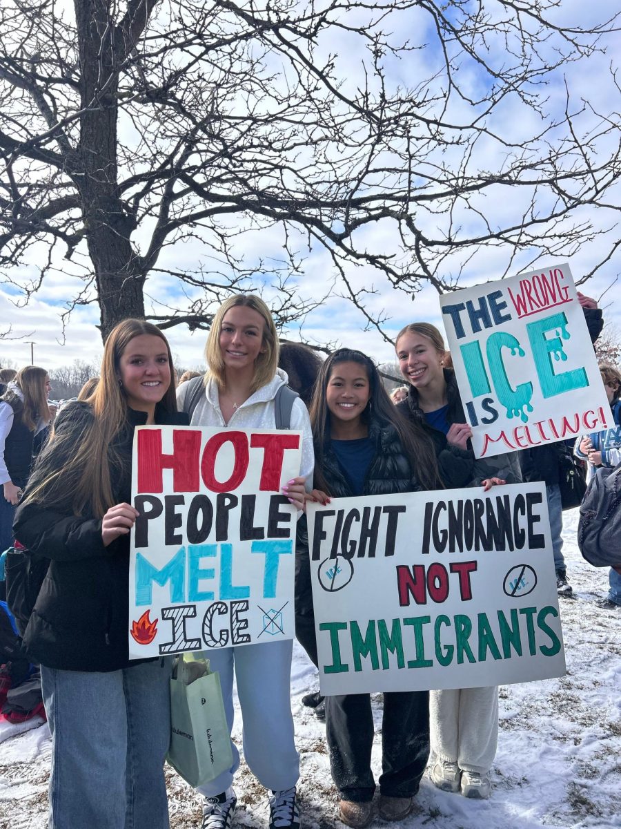 Sophomores holding up anti-ICE posters at the protest on Wednesday February 4th