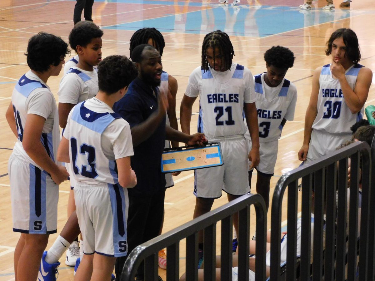Coach Jackson talks to his players in a huddle