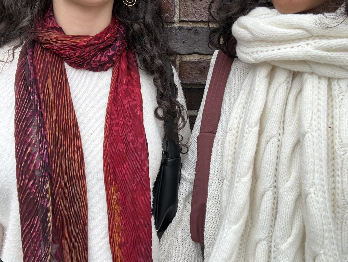 Friends coordinate their winter looks with matching scarves and simple jewelry, using small details to tie their outfits together while keeping their styles unique.