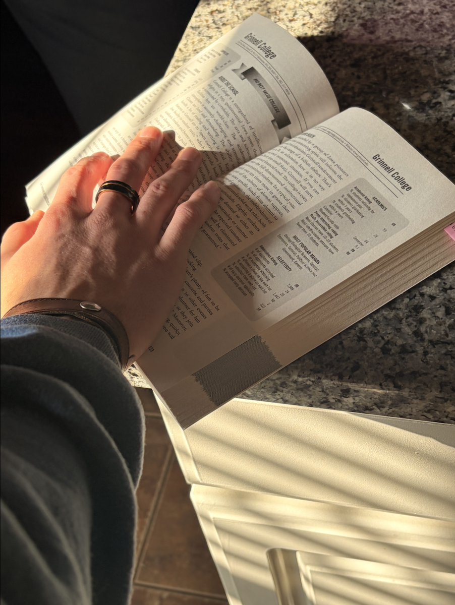 Skyline student Cole Sangsland ('29) cracking open a college exploration book