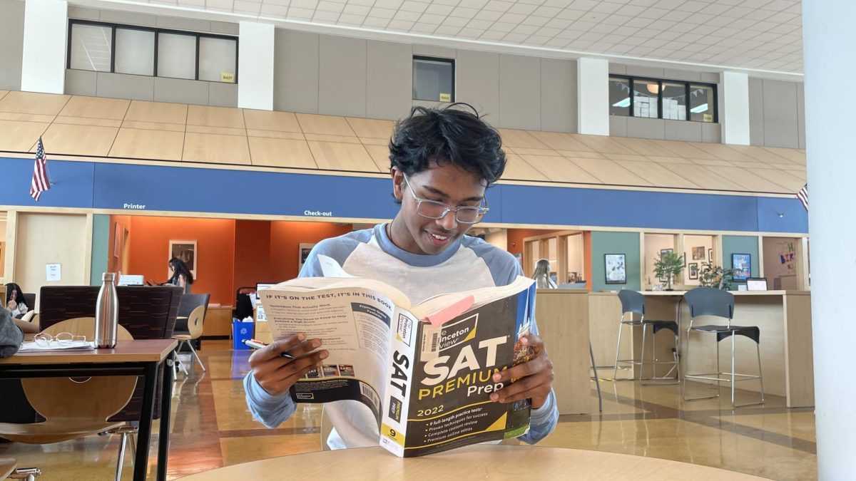 Medhansh Vrat ('27) reads a SAT Prep book in preparation for the SAT.