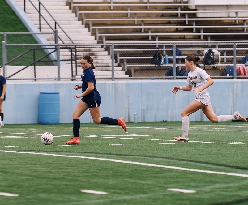 Kate Sauld ('29) controlling the ball in soccer game against Saline.