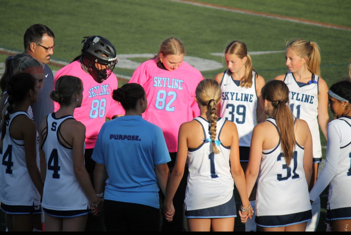 Skyline field hockey team in huddle before a game.