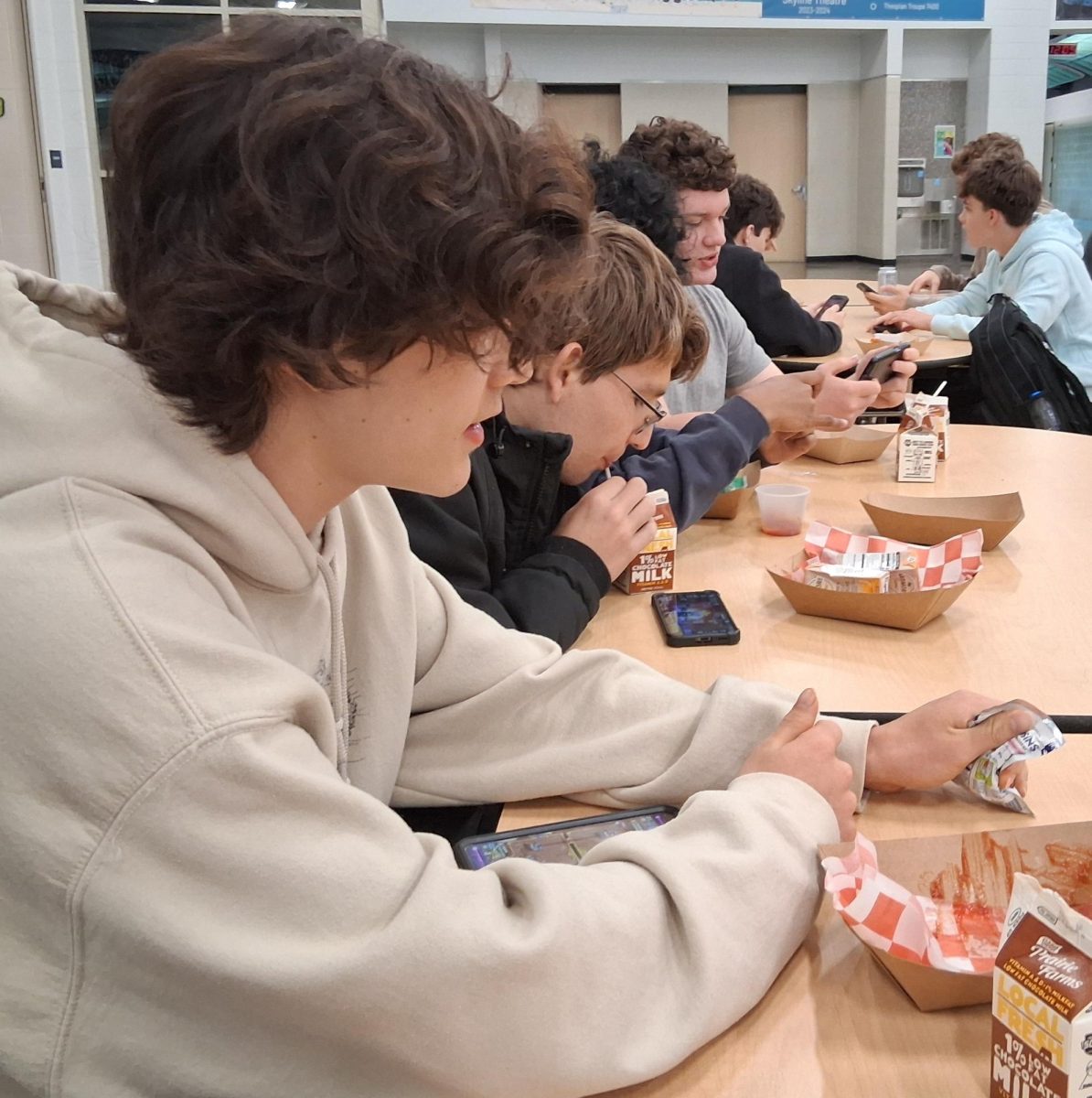 Students on their phones during lunchtime