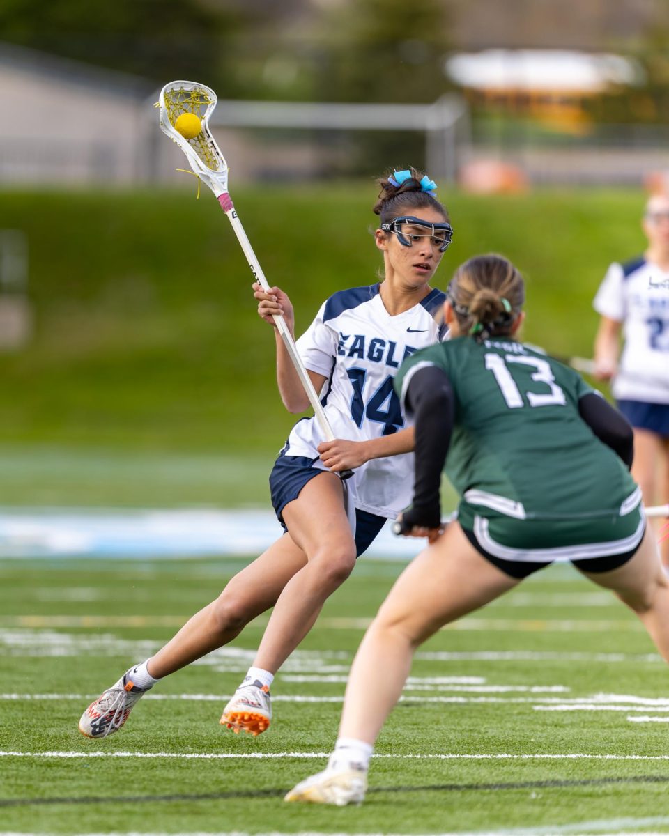 Gabi Arocha ('26) cradles the ball in a game against Father Gabriel Richard.