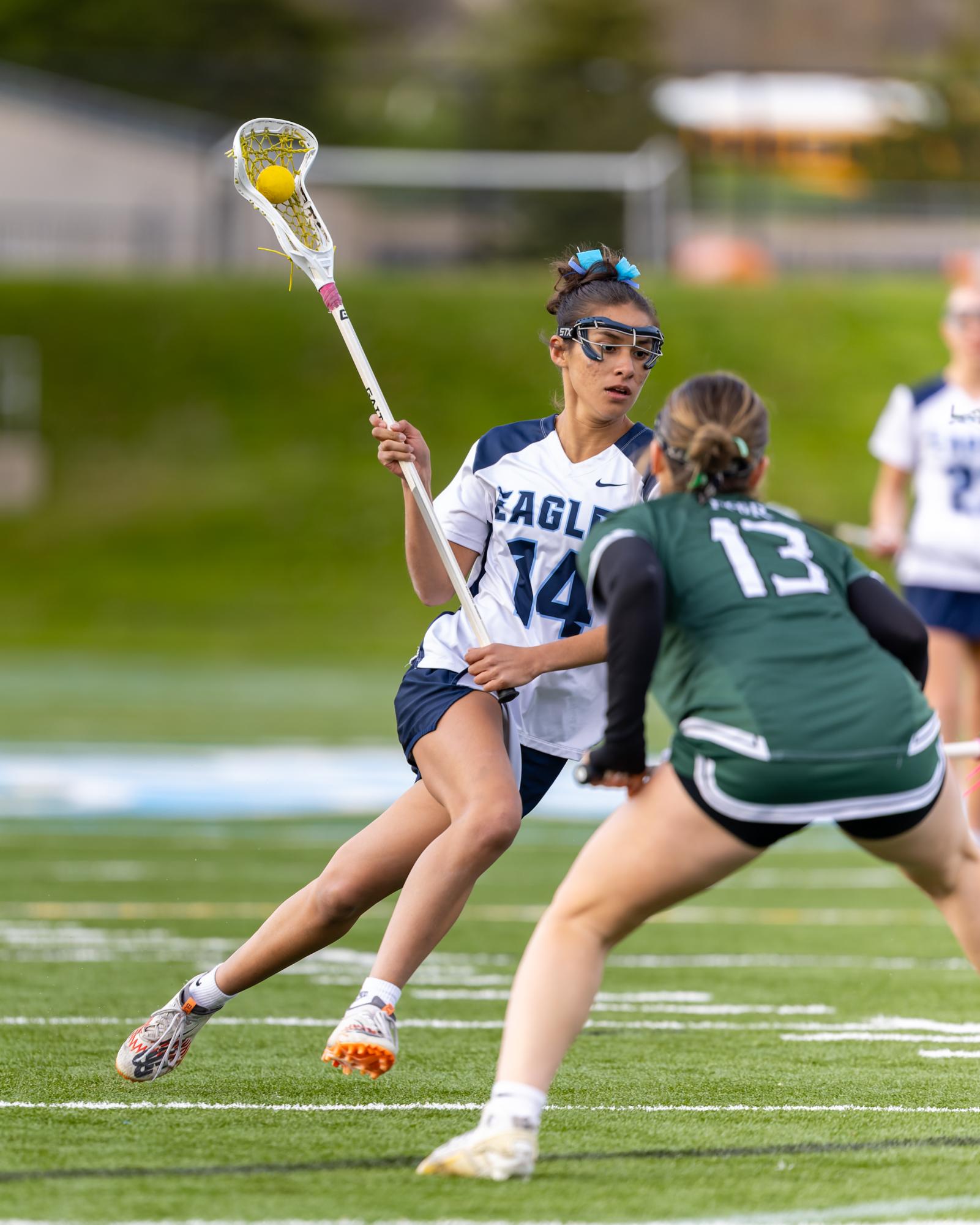 Gabi Arocha ('26) cradles the ball in a game against Father Gabriel Richard.